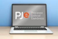 FOTO DE UM NOTEBOOK PJE PROCESSO JUDICIAL ELETRÔNICO ESCRITO AO CENTRO.