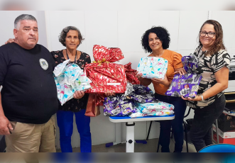 Há um homem e três mulheres. Eles seguram presentes.
