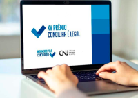 FOTO DE UM NOTEBOOK COM O NOME XV PRÊMIO CONCILIAR É LEGAL ESCRITO EM LETRAS AZUIS SOBRE UM FUNDO BRANCO