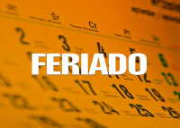 Há um calendário de fundo laranja com números pretos. No centro da imagem está escrito calendário com letras brancas.