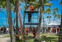 corpo de bombairos em cima de uma andaime fazendo segurando um homem