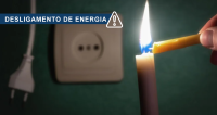 Card de fundo verde. Há um interruptor com auma tomada fora dele. E há uma mão ascendendo uma vela.